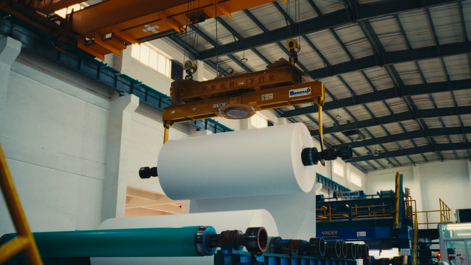 Finished paper roll being craned onto the winder at the Jiangmen plant